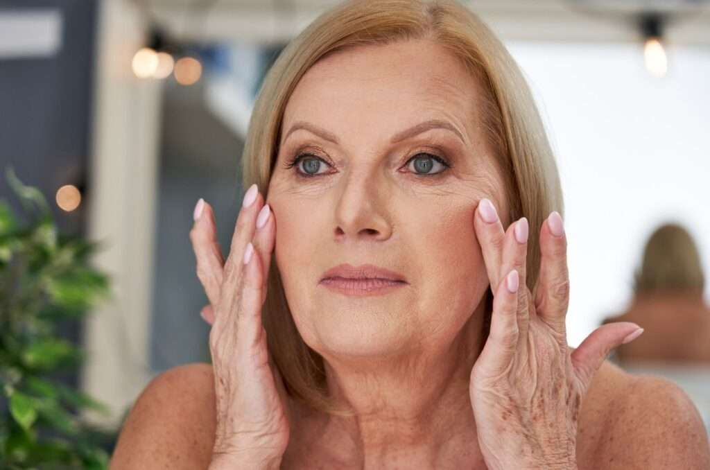 senior woman using anti wrinkle cream