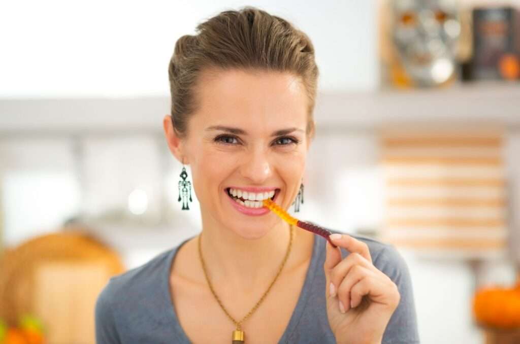 smiling young lady eating gummies