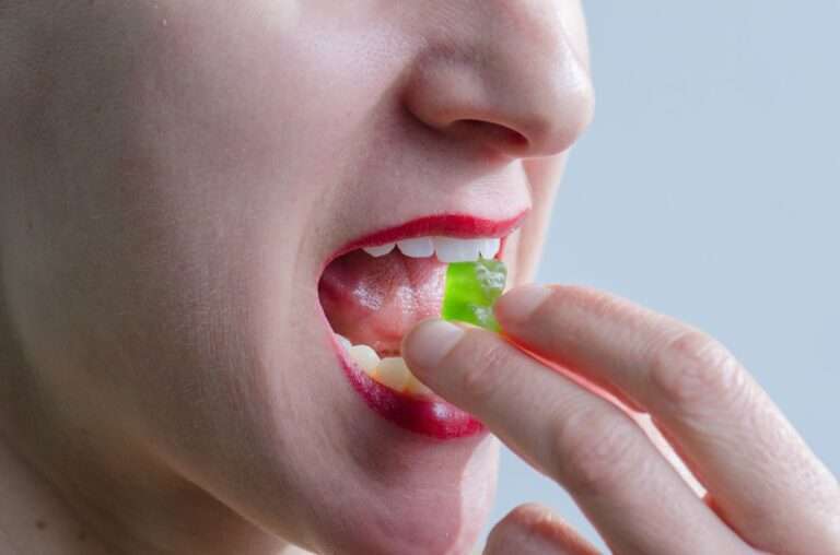 woman eating green gummy