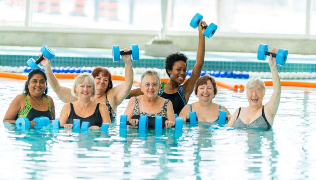 group of adult women doing water aerobics